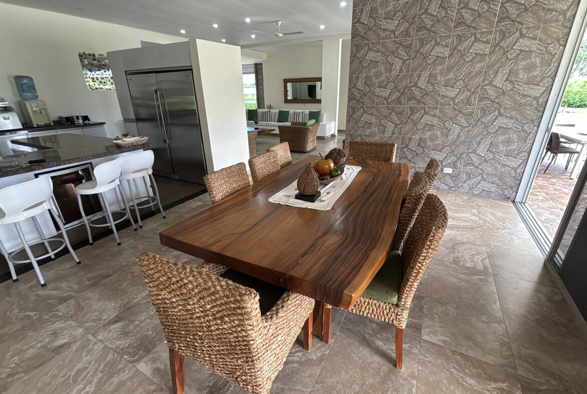 Amplio comedor en casa campestre en Hacienda Las Victorias, Ibagué, con mobiliario de madera y vista.